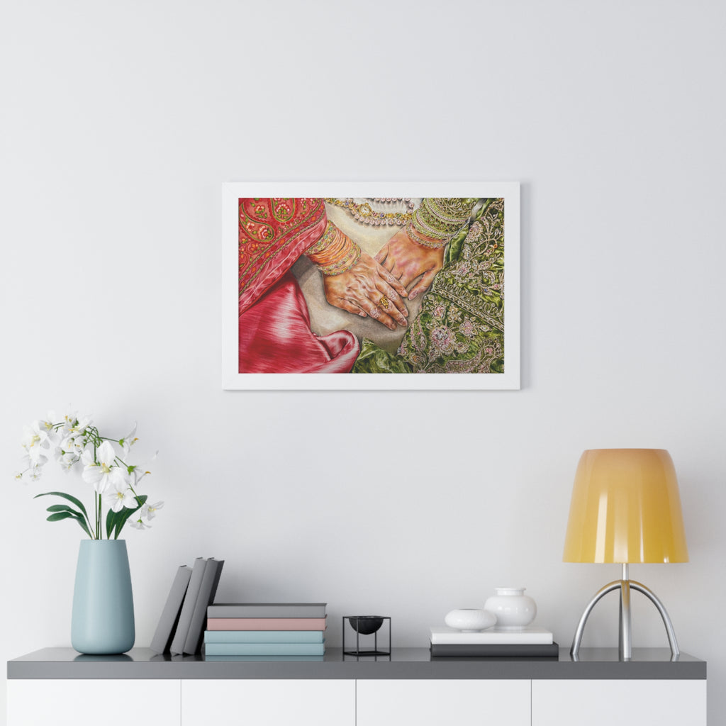 Framed artwork of hands holding flowers on a wall above a shelf with decor items.